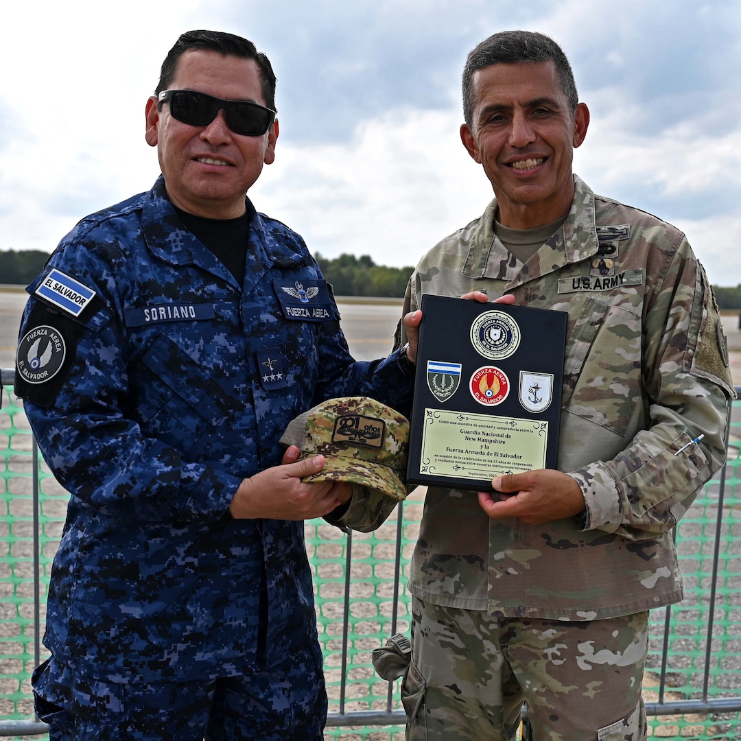 From left, Col. Pablo Soriano, chief of the Salvadoran Air Force, presents NH Adjutant Gen. David Mikolaities with a gift and plaque at the Thunder Over New Hampshire Air Show on Sept. 6, 2025, at Pease Air National Guard Base in Newington, N.H.