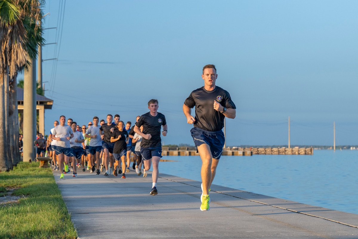 Members of the Air Force Technical Applications Center hit the ground running along the Indian River at Patrick Space Force Base, Fla., during the center’s 5K Warrior Run Aug. 28, 2025.    (U.S. Air Force photo by Matthew S. Jurgens)
