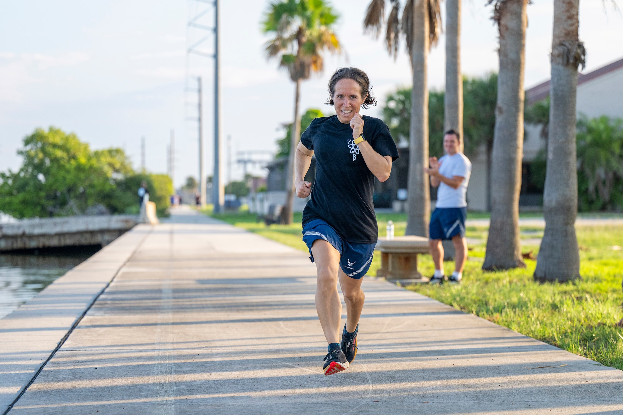 Lt. Col. Ilea Heft, commander of the U.S. Air Force Radiochemistry Laboratory at Patrick Space Force Base, Fla., makes the final dash to the finish line during the Air Force Technical Applications Center’s 5K Warrior Run held Aug. 28. 2025.  (U.S. Air Force photo by Matthew S. Jurgens)