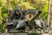 A soldier from the 1st Battalion, 4th Infantry Regiment spots enemy positions from his tank while posing as OPFOR during Saber Junction 25 at the Hohenfels Training Area, Joint Multinational Readiness Center (JMRC), Germany Sep. 4, 2025.