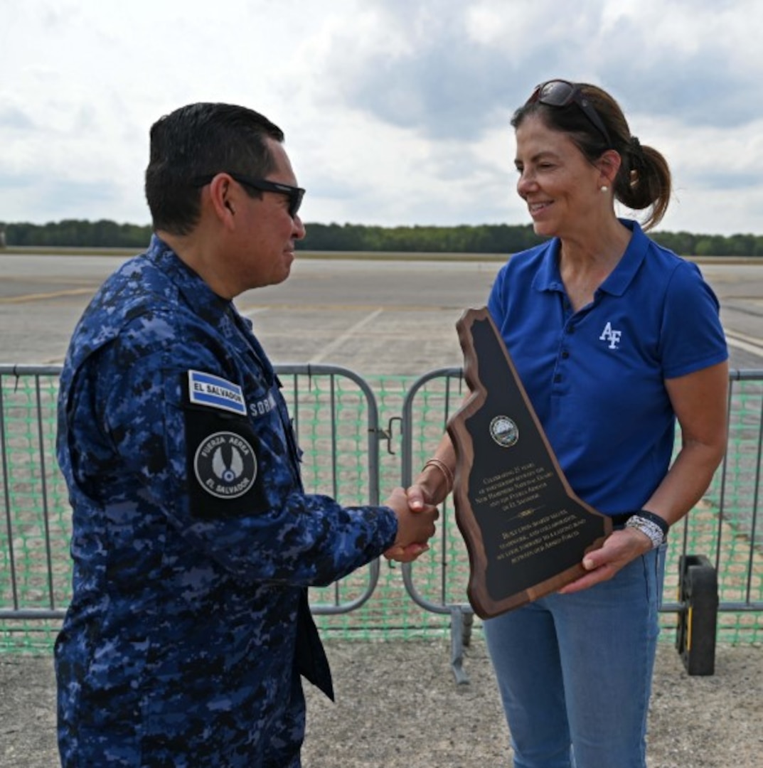 NH Gov. Kelly Ayotte presents Col. Pablo Soriano, chief of staff of the Salvadoran Air Force, with a plaque to commemorate the 25th anniversary of the New Hampshire National Guard-El Salvador State Partnership Program on Sept. 6, 2025, at Pease Air National Guard Base in Newington, N.H.