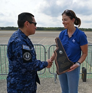 NH Gov. Kelly Ayotte presents Col. Pablo Soriano, chief of staff of the Salvadoran Air Force, with a plaque to commemorate the 25th anniversary of the New Hampshire National Guard-El Salvador State Partnership Program on Sept. 6, 2025, at Pease Air National Guard Base in Newington, N.H.