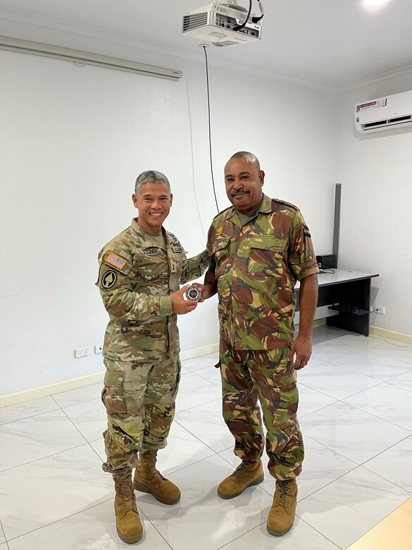 U.S. Army Maj. Gen. Lance Okamura, deputy commanding general for homeland affairs at U.S. Army Pacific, left, presents a coin to Brig. Lari Opa, deputy chief of the Papua New Guinea Defence Force, following Army-to-Army Staff Talks at Murray Barracks in Port Moresby, Papua New Guinea, on Sept. 2, 2025.