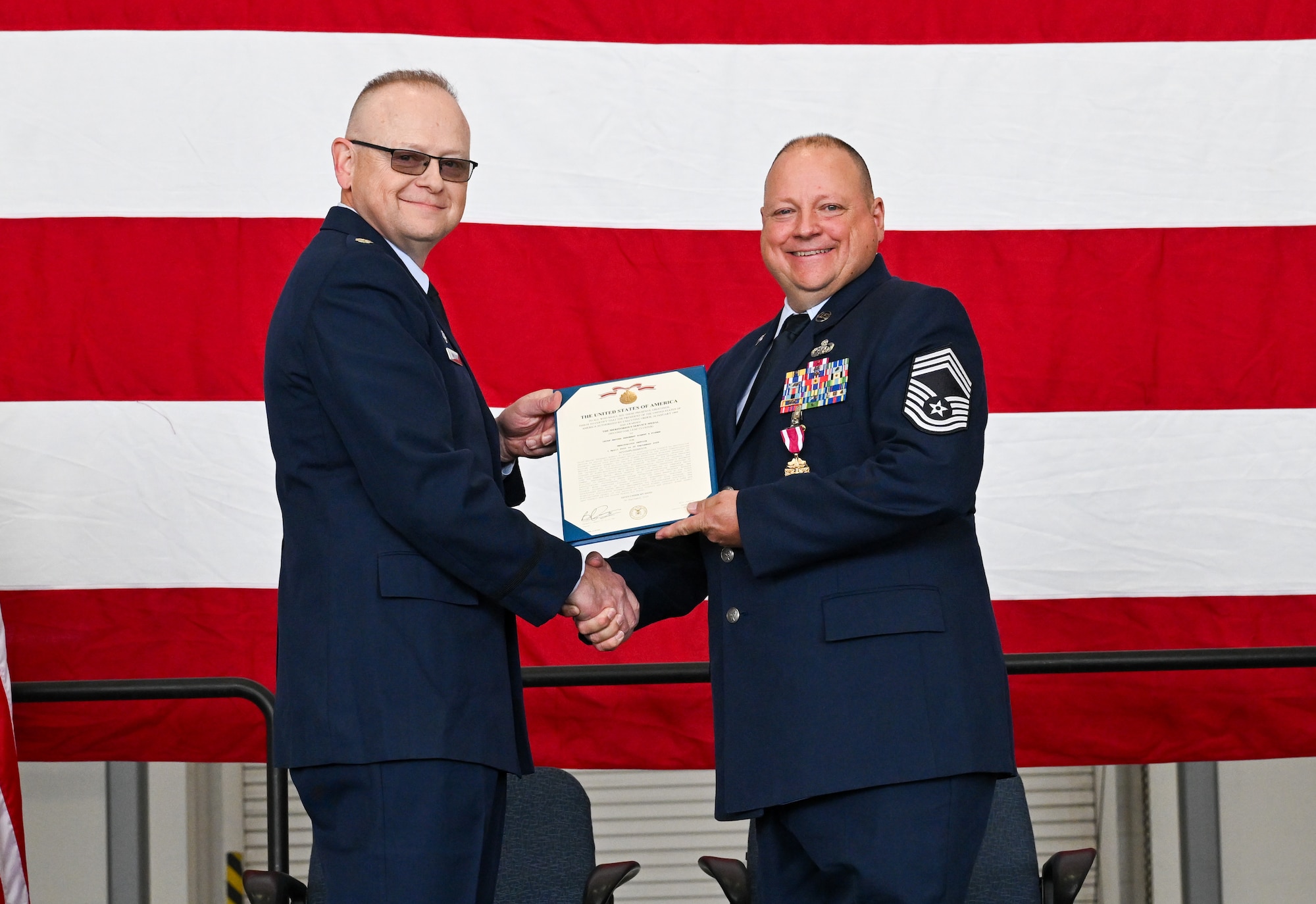 Lt. Col. Russell Whitlock, 910th Force Support Squadron commander, poses for a photo with Chief Master Sgt. Robert Fisher, 910th Communications Squadron senior enlisted leader during Fisher’s retirement ceremony at Youngstown Air Reserve Station, Ohio, Sept. 6, 2025.
