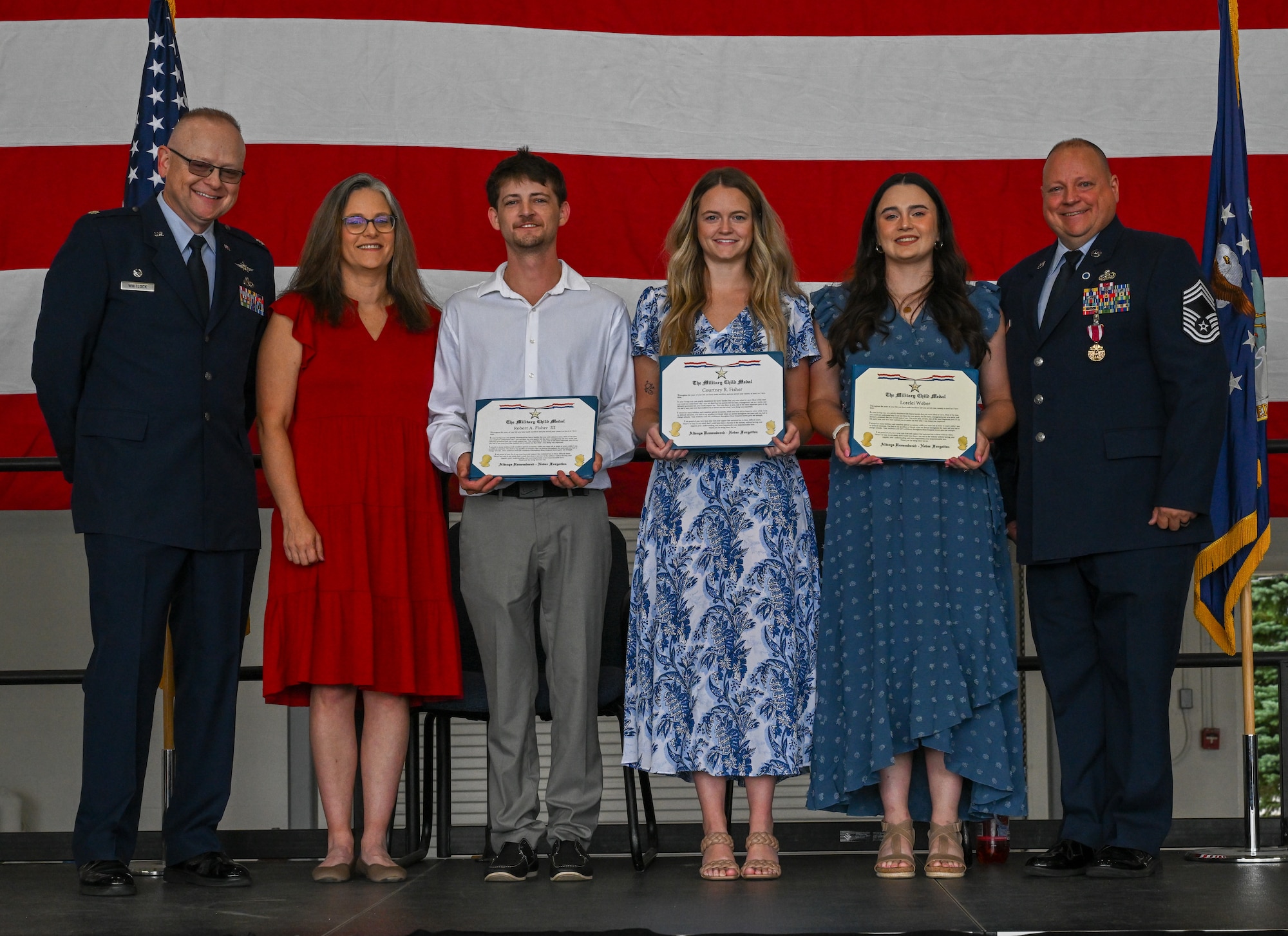 Chief Master Sgt. Robert Fisher, 910th Communications Squadron senior enlisted leader poses for a photo with his family during his retirement ceremony at Youngstown Air Reserve Station, Ohio, Sept. 6, 2025.