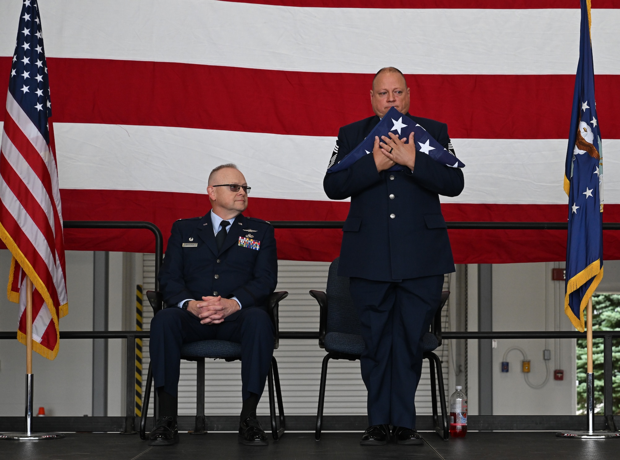 Chief Master Sgt. Robert Fisher, 910th Communications Squadron senior enlisted leader clutches the American flag during his retirement ceremony at Youngstown Air Reserve Station, Ohio, Sept. 6, 2025.