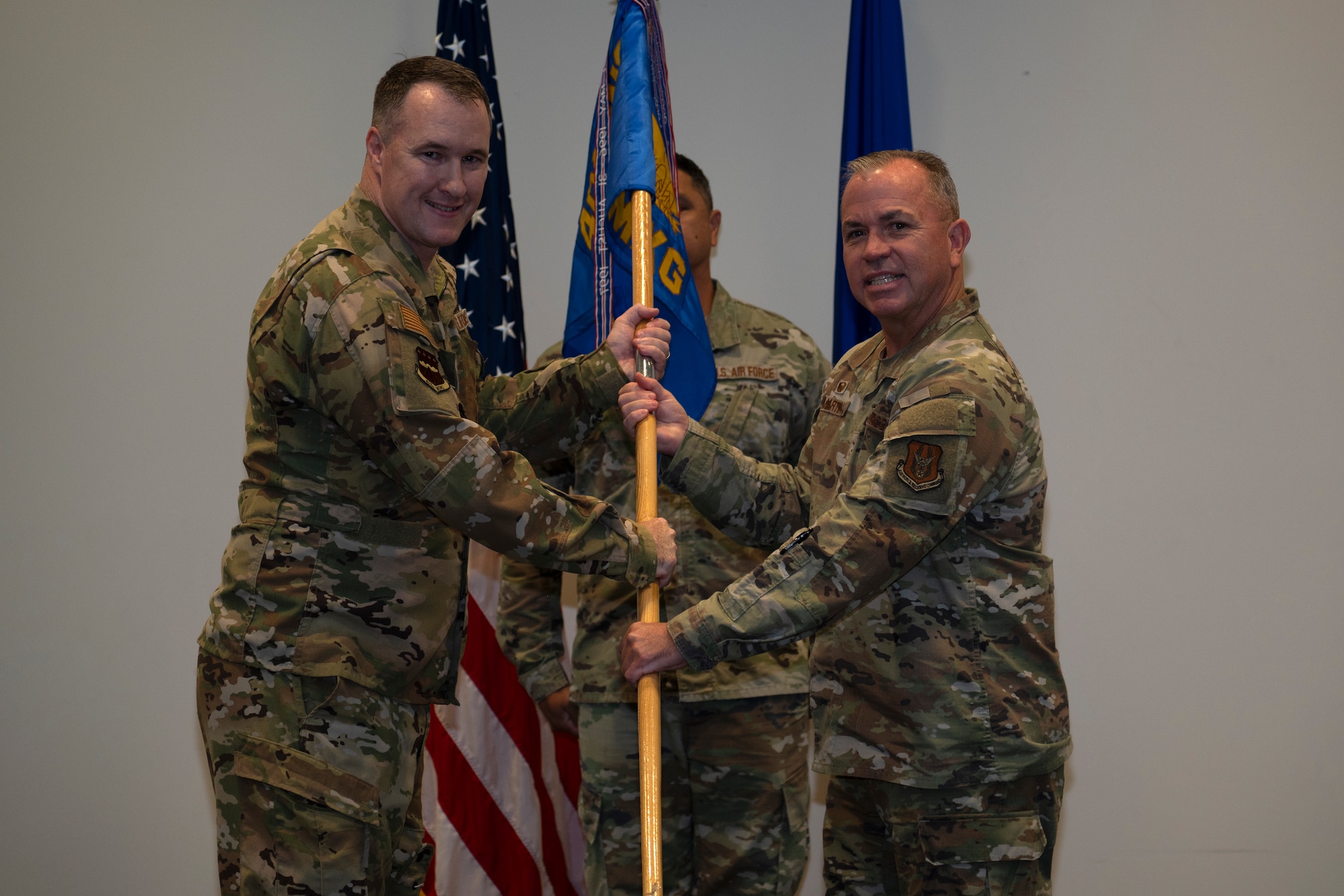 Col. Fish passes the 403rd Maintenance Group guidon to Col. Martin.