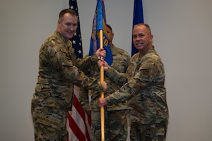 Col. Fish passes the 403rd Maintenance Group guidon to Col. Martin.