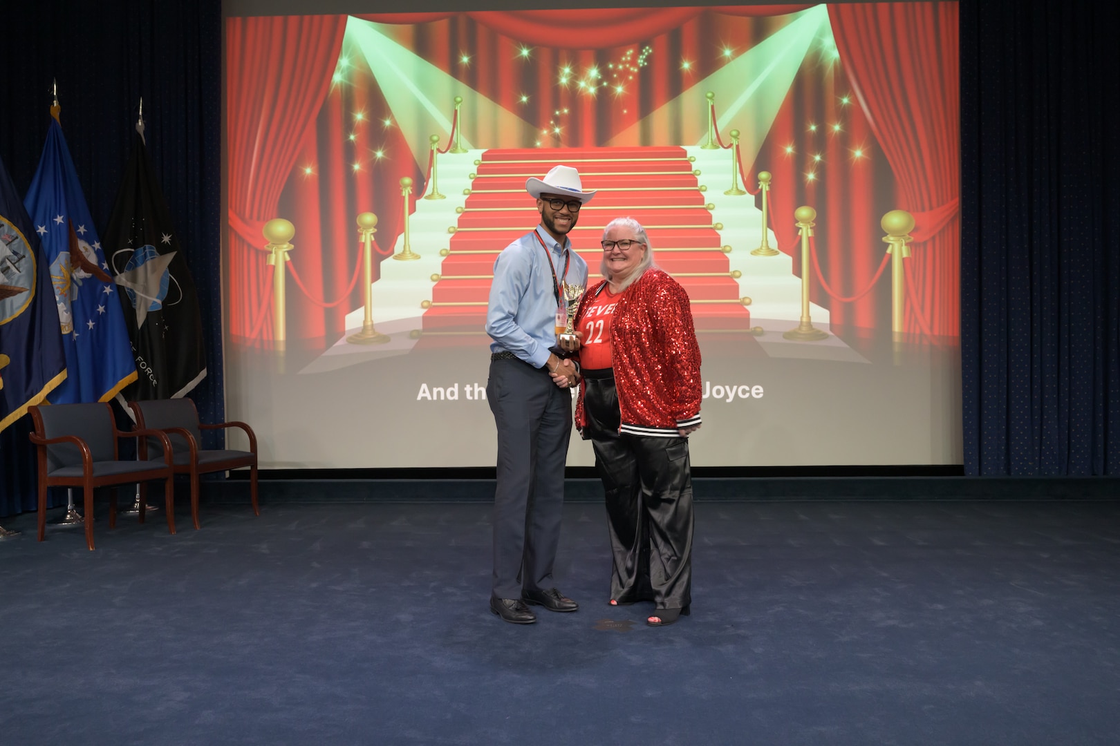 One man and one woman standing together on a stage.