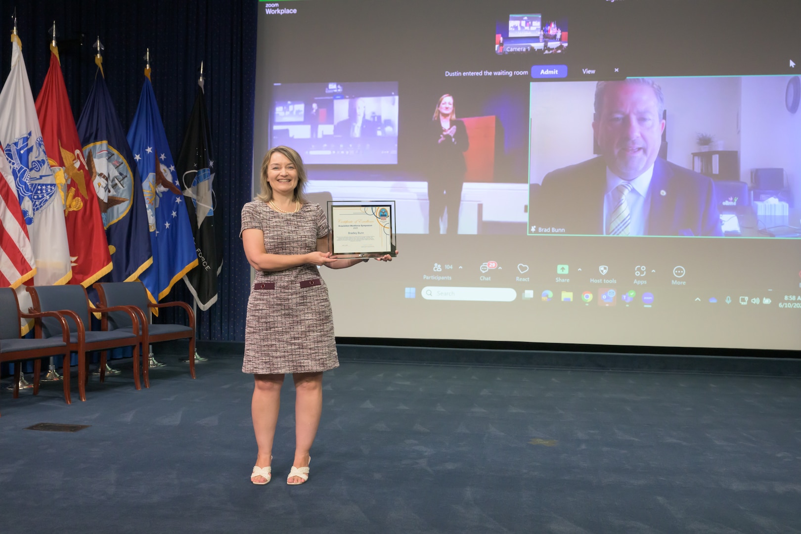 Woman standing alone holding a certificate