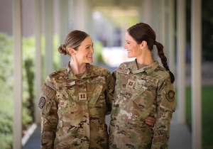 Two twin sisters pose for a photo at Travis Air Force Base