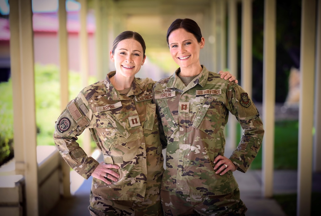 Two twin sisters pose for a photo at Travis Air Force Base