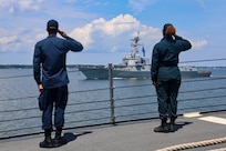 (July 18, 2025) Operations Specialist 2nd Class Aaron Diaz (left) and Boatswain’s Mate 3rd Class Sanaa Cooks (right) assigned to the Arleigh Burke-class guided-missile destroyer USS Bulkeley (DDG 84) pass honors and salute the USS Thomas Hudner (DDG 116) during a sea-and-anchor detail. USS Bulkeley is on a scheduled deployment in the U.S. 6th Fleet area of operations to support the warfighting effectiveness, lethality and readiness of U.S. Naval Forces Europe-Africa, and defend U.S., Allied and partner interests in the region. (U.S. Navy photo by Mass Communication Specialist 2nd Class Jonathan Nye)