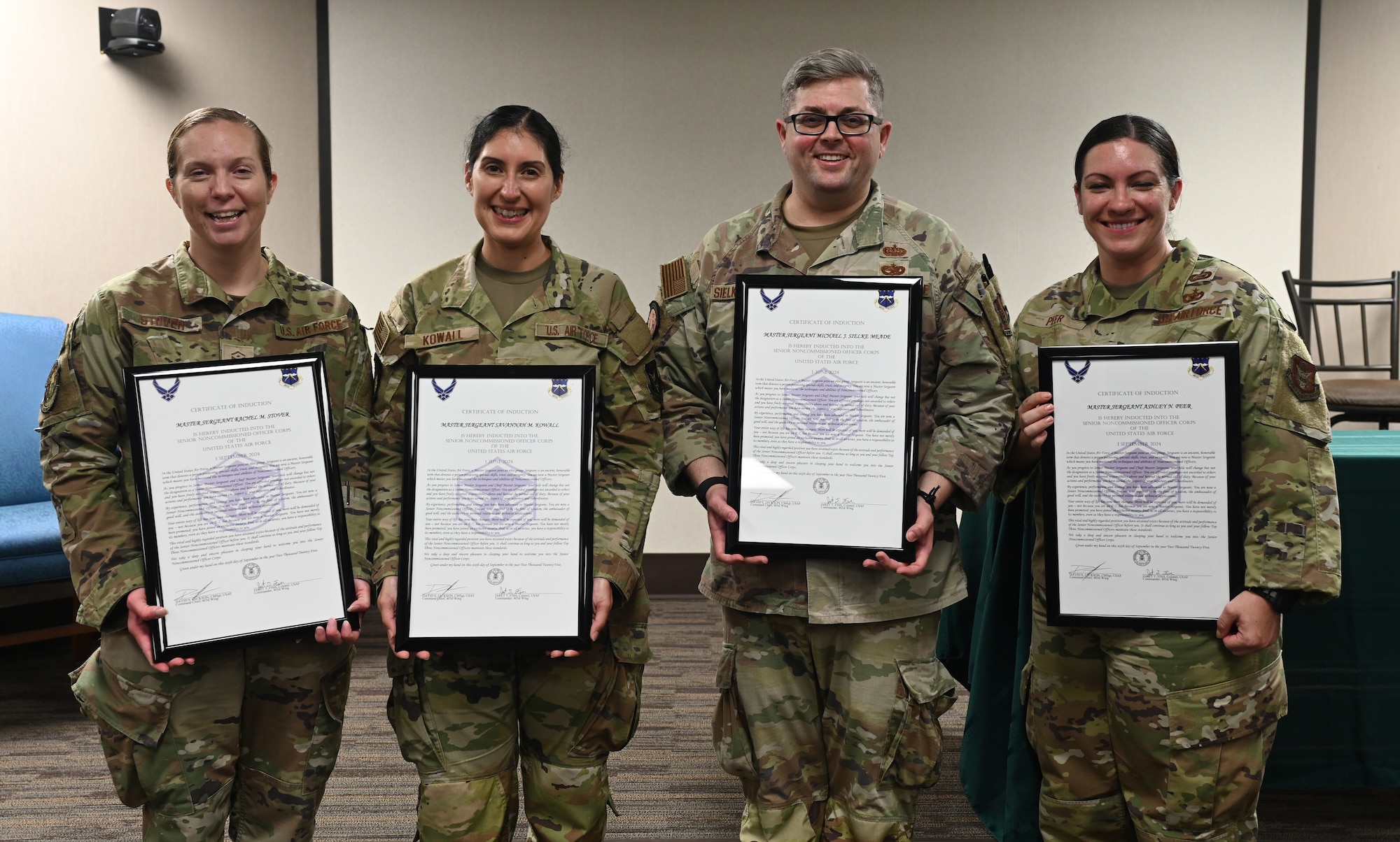 Group photo of Master Sgt. inductees holding their certificates.