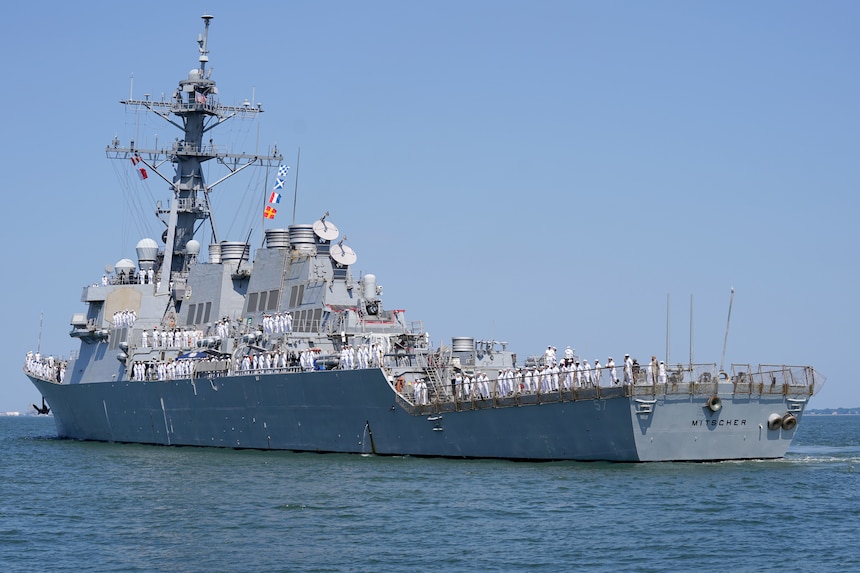 The Arleigh Burke-class guided-missile destroyer USS Mitscher (DDG 57) departs Naval Station Norfolk, July 25, for a regularly scheduled deployment as part of the Gerald R. Ford Carrier Strike Group (GRFCSG). The GRFCSG is deployed to the U.S. European Command area of responsibility to underpin American security and economic prosperity, deter adversaries, and project power on a global scale through sustained operations at sea. (U.S. Navy photo by Mass Communication Specialist 1st Class Clay M. Whaley)