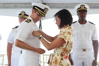 NAVAL STATION NORFOLK, VA (Jul. 25, 2025) Cmdr. Michael Schenk receives his Command-at-Sea pin as the Commanding Officer of the Arleigh Burke-class guided-missile destroyer USS Gonzalez (DDG 66) from his wife, Lacey. Gonzalez is the U.S. Navy’s 16th Arleigh Burke-class destroyer. The warship is homeported at Naval Station Norfolk and is a part of Destroyer Squadron 22, along with Carrier Strike Group 10, led by the USS George H.W. Bush. (U.S. Navy photo by Hull Maintenance Technician Third Class Xavier Wheeler).
