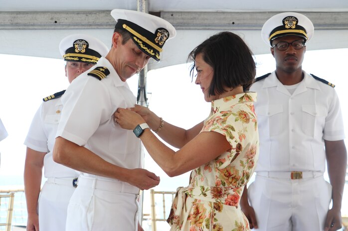 NAVAL STATION NORFOLK, VA (Jul. 25, 2025) Cmdr. Michael Schenk receives his Command-at-Sea pin as the Commanding Officer of the Arleigh Burke-class guided-missile destroyer USS Gonzalez (DDG 66) from his wife, Lacey. Gonzalez is the U.S. Navy’s 16th Arleigh Burke-class destroyer. The warship is homeported at Naval Station Norfolk and is a part of Destroyer Squadron 22, along with Carrier Strike Group 10, led by the USS George H.W. Bush. (U.S. Navy photo by Hull Maintenance Technician Third Class Xavier Wheeler).