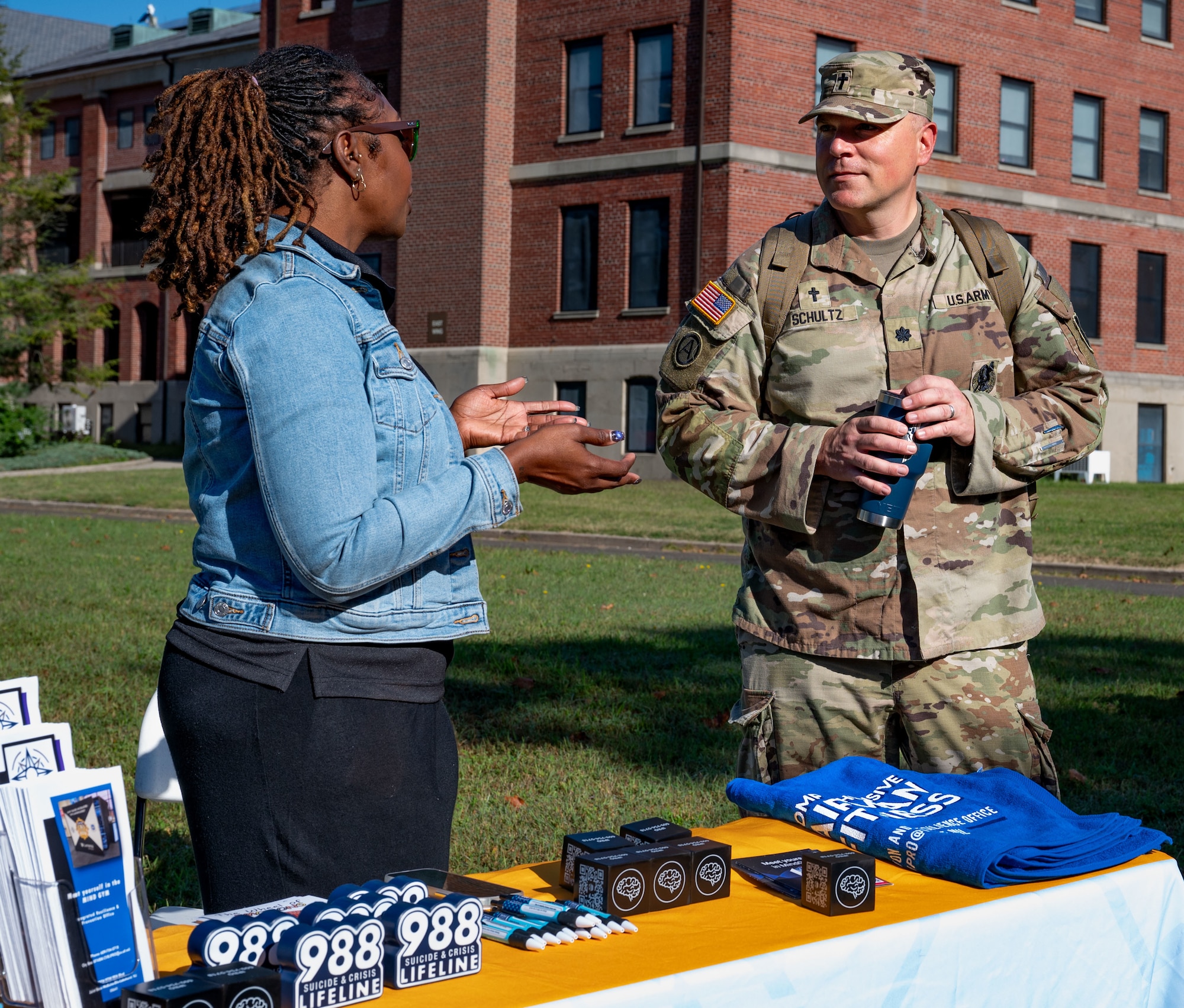 Nicole Moss, 87th Air Base Wing Integrated Prevention and Response director, provides information and resources to U.S. Army Chaplain (Lt. Col.) Richard Shultz, U.S. Army Support Activity garrison chaplain, at the “Be the Anchor” ruck march Sept. 3, 2025, at Joint Base McGuire-Dix-Lakehurst, N.J. Service members visited different JB MDL helping agencies to learn about resources available to them.
