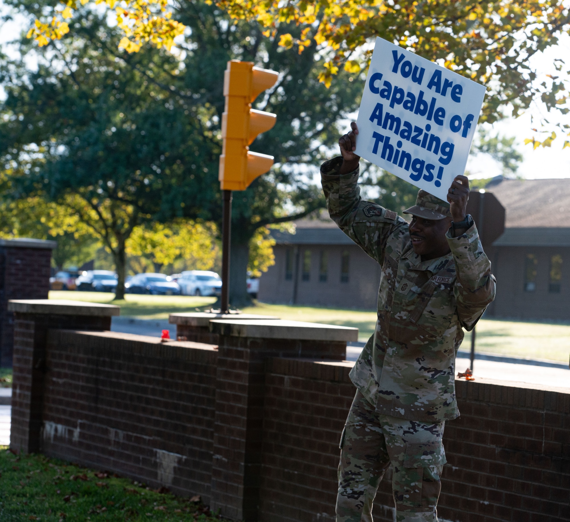 U.S. Air Force Chief Master Sgt. Nicholas Conner, 87thAir Base Wing command chief, holds a sign at the main gate entrance at Joint Base McGuire-Dix-Lakehurst, N.J., Sept. 8, 2025. Service members and Department of Defense civilians held signs of encouragement at the main gate in support of suicide prevention.