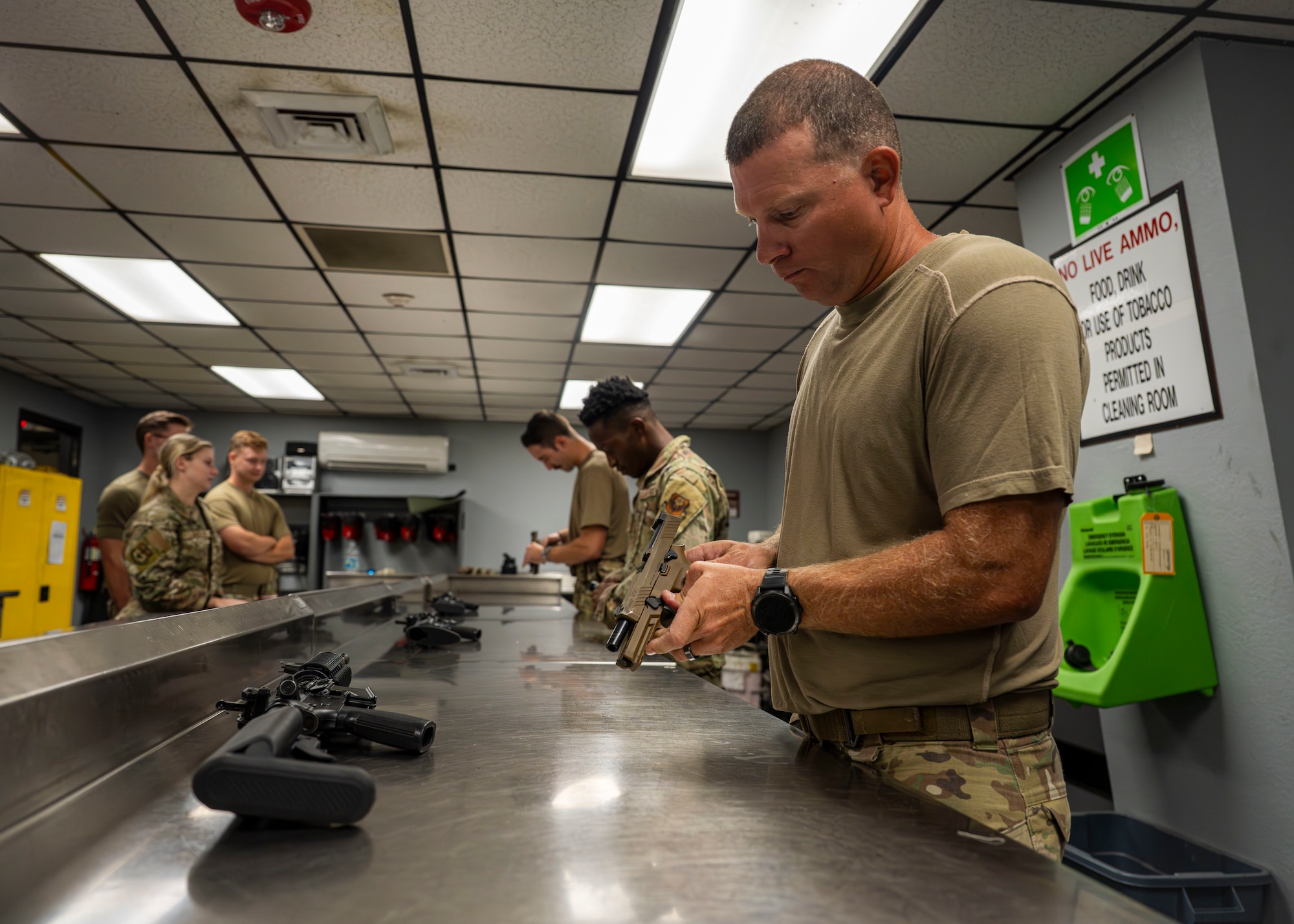 A U.S. Airman assigned to the 1st Special Operations Wing disassembles a Sig Sauer M18 pistol during a combat arms training and maintenance qualification test at Hurlburt Field, Florida