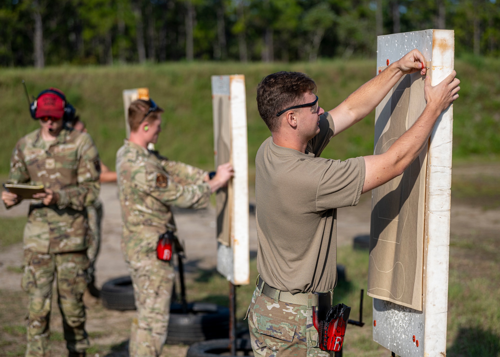 U.S. Airmen assigned to the 1st Special Operations Wing mount targets for a combat arms training and maintenance qualification
test at Hurlburt Field, Florida