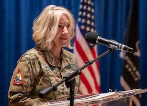 A Chief Master Sergeant in the Space Force talks at a podium.