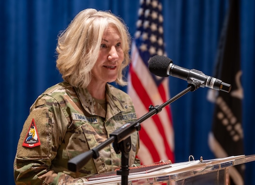 A Chief Master Sergeant in the Space Force talks at a podium.