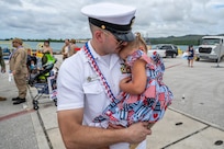 NAVAL BASE GUAM (August 31, 2025) Master Chief Information Systems Technician (Communications) Chris Ries, chief of the boat of the Los Angeles-class fast-attack submarine USS Springfield (SSN 761) shares a hug with his child, August 31, 2025. Springfield returns to its homeport at Naval Base Guam after completing a routine deployment in the Indo-Pacific. Assigned to Commander, Submarine Squadron 15, based at Polaris Point, Naval Base Guam, Springfield is one of five forward-deployed fast-attack submarines. Renowned for their unparalleled speed, endurance, stealth, and mobility, fast-attack submarines are the backbone of the Navy’s submarine force. Regarded as apex predators of the sea, Guam’s fast-attack submarines serve at the tip of the spear, helping to reaffirm the submarine force's forward-deployed presence in support of a free and open Indo-Pacific. (U.S. Navy photo by Lt. James Caliva)