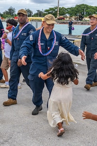 NAVAL BASE GUAM (August 31, 2025) A Sailors assigned to the Los Angeles-class fast-attack submarine USS Springfield (SSN 761) runs to greet his child, August 31, 2025. Springfield returns to its homeport at Naval Base Guam after completing a routine deployment in the Indo-Pacific. Assigned to Commander, Submarine Squadron 15, based at Polaris Point, Naval Base Guam, Springfield is one of five forward-deployed fast-attack submarines. Renowned for their unparalleled speed, endurance, stealth, and mobility, fast-attack submarines are the backbone of the Navy’s submarine force. Regarded as apex predators of the sea, Guam’s fast-attack submarines serve at the tip of the spear, helping to reaffirm the submarine force's forward-deployed presence in support of a free and open Indo-Pacific. (U.S. Navy photo by Lt. James Caliva)