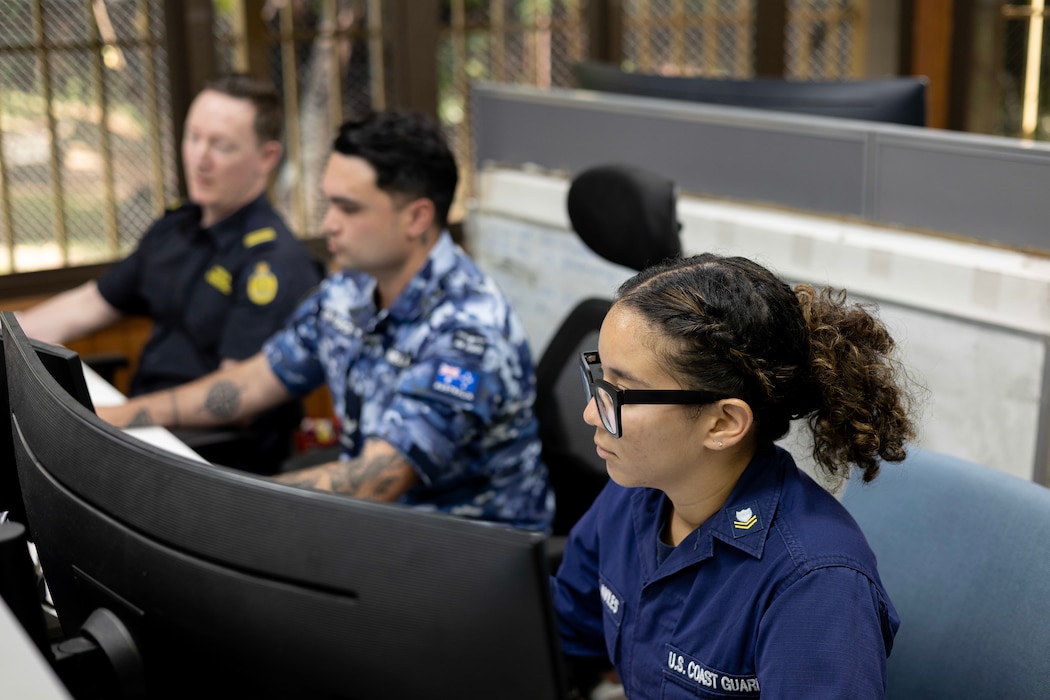 United States Coast Guard, Petty Officer Second Class Nathalie Aviles (R), Royal Australian Air Force, Corporal Matthew Dunnell, and Senior Border Force Officer Richard Noad at the Forum Fisheries Agency, Honiara, Solomon Islands.