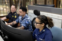 United States Coast Guard, Petty Officer Second Class Nathalie Aviles (R), Royal Australian Air Force, Corporal Matthew Dunnell, and Senior Border Force Officer Richard Noad at the Forum Fisheries Agency, Honiara, Solomon Islands.