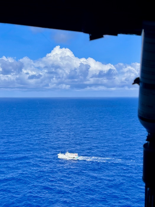 Petty Officer 2nd Class Nathalie Aviles takes a photo of a fishing vessel operating in the Solomon Sea on Aug. 12, 2025, while aboard a a Royal Australian Air Force C-27J Spartan flight as part of Operation Island Chief. U.S. Coast Guard members played a pivotal role in the success of Operation Island Chief 2025 (OPIC25), a multinational maritime surveillance operation conducted from Aug. 4-15.