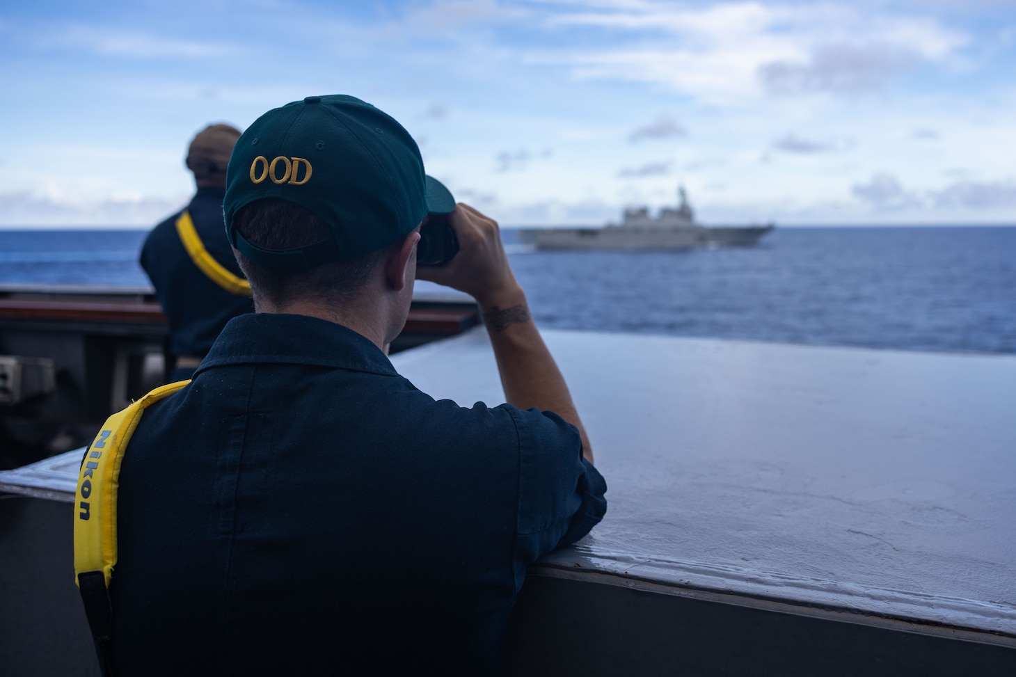 Lt. j.g. Khalil Martinez, from Berkley, California stands watch on a bridge wing of the Arleigh Burke-class guided-missile destroyer USS Higgins (DDG 76) while conducting bilateral operations alongside the Japan Maritime Self-Defense Force ship JS Ise (DDH 182) in the Philippine Sea, Sept. 5.