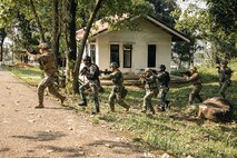 U.S. Marines with Weapons Company, 2nd Battalion, 1st Marine Regiment, Marine Rotational Force – Darwin 25.3, a Royal Dutch Marine, an Indonesian Marine, and Japan Ground Self-Defense Force soldier run across the street during close quarters battle drills during Super Garuda Shield 25 in Jakarta, Indonesia, Aug. 27, 2025.