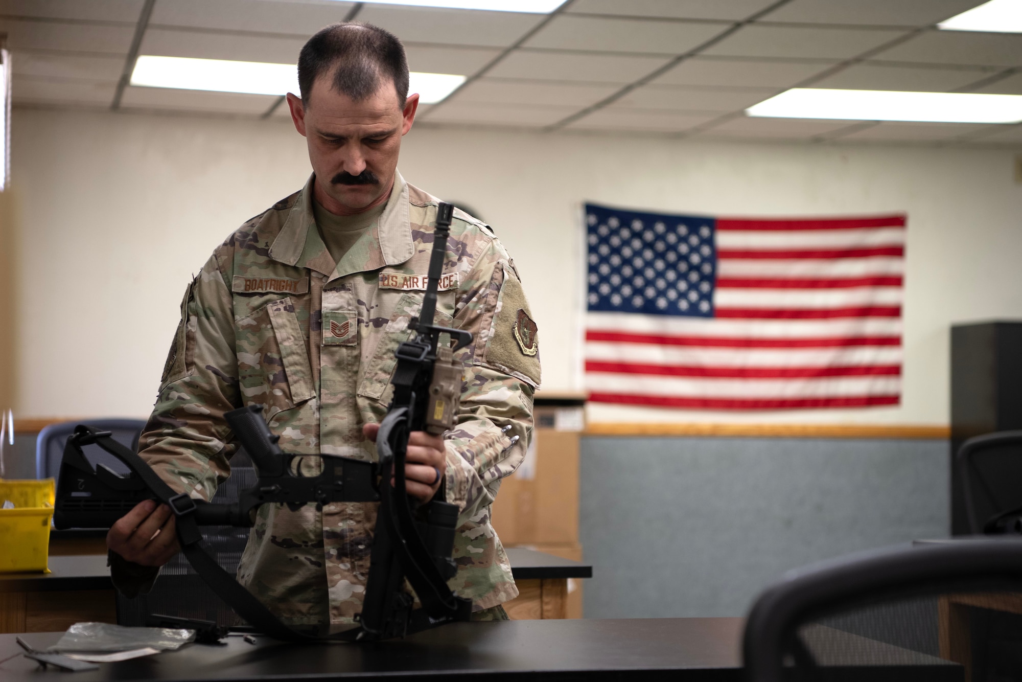 LUKE AIR FORCE BASE, Ariz. – Tech. Sgt. Steven Boatright, 944th Security Forces Squadron combat arms training and maintenance instructor, prepares weapons gear at Luke Air Force Base, Ariz., Aug. 8, 2025. Boatright balances his role as an Air Force Reserve instructor, Department of the Air Force civilian, and reserve deputy sheriff while raising a family and serving his community as a foster parent. (U.S. Air Force photo by Tech. Sgt. Tricia Topasna)