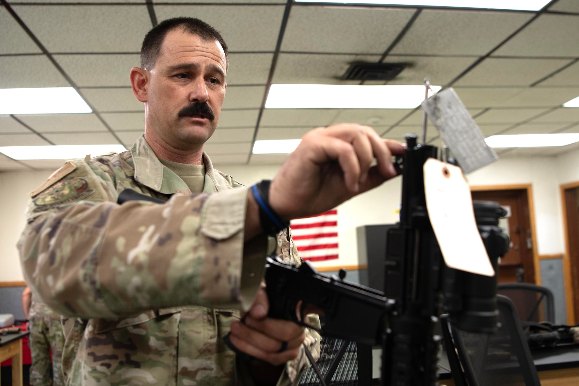 LUKE AIR FORCE BASE, Ariz. – Tech. Sgt. Steven Boatright, 944th Security Forces Squadron combat arms training and maintenance instructor, adjusts a rifle during combat arms duties at Luke AFB, Ariz., Aug. 8, 2025. He says his mission remains the same across all uniforms — to serve, protect and uplift others. (U.S. Air Force photo by Tech. Sgt. Tricia Topasna)
