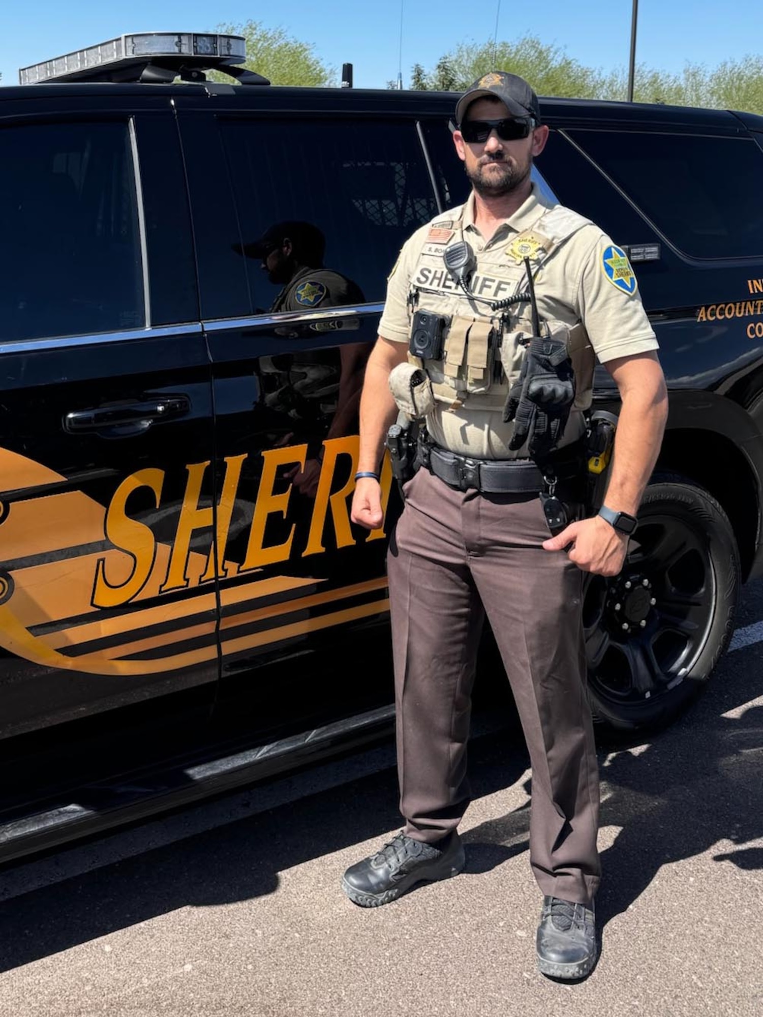 LUKE AIR FORCE BASE, Ariz. – Tech. Sgt. Steven Boatright stands in front of his Maricopa County Sheriff’s Office patrol car in Ariz., Aug. 8, 2025. As a reserve deputy, he responds to calls for service on weekends, bringing the same calm and disciplined approach that he uses in the Air Force Reserve. (U.S. Air Force Courtesy Photo)