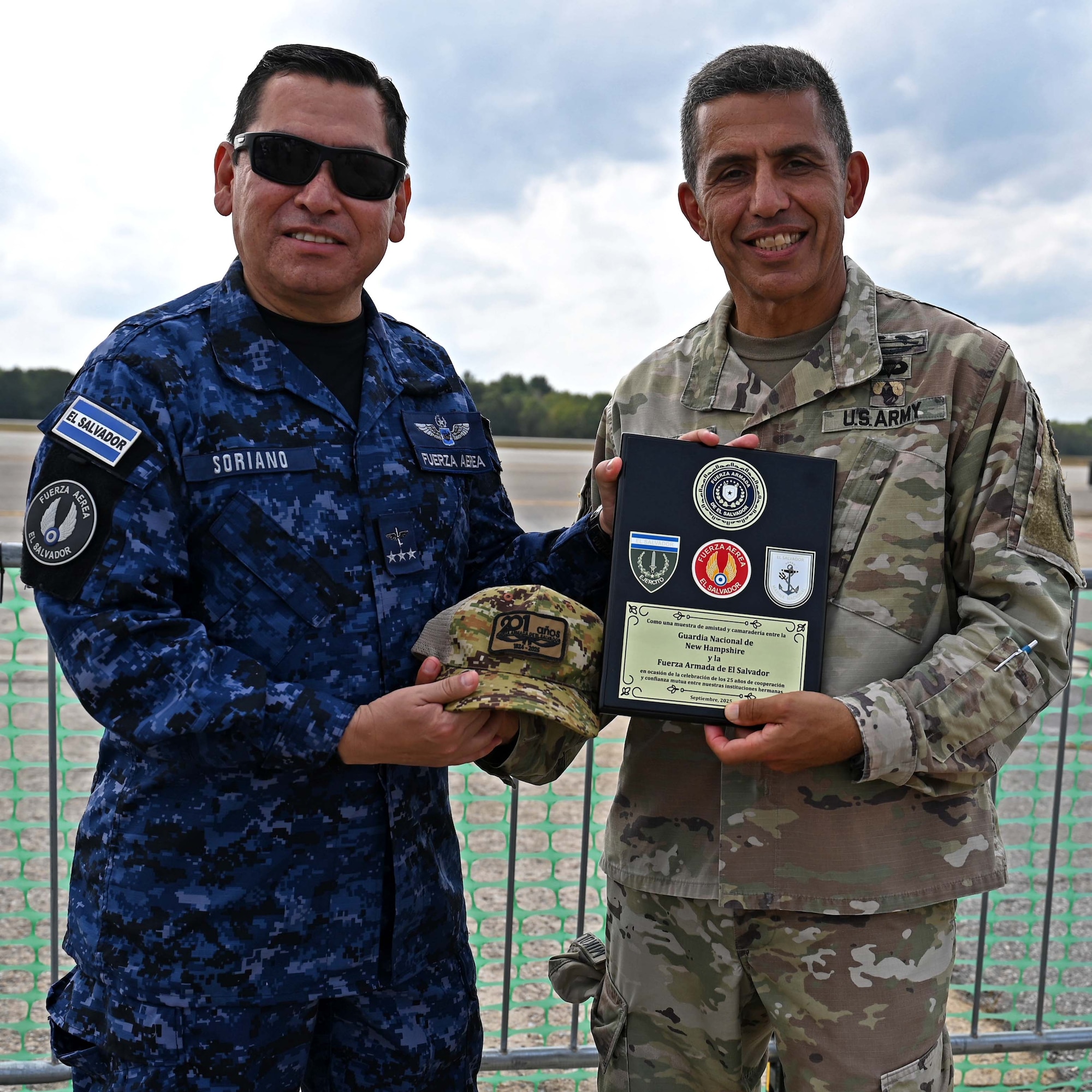 From left, Col. Pablo Soriano, chief of the Salvadoran Air Force, presents NH Adjutant Gen. David Mikolaities with a gift and plaque at the Thunder Over New Hampshire Air Show on Sept. 6, 2025, at Pease Air National Guard Base in Newington, N.H.