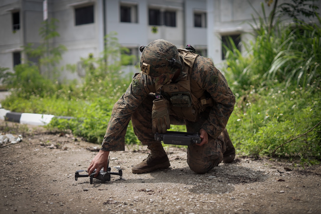 U.S. Marine Corps Cpl. Rijohn Adams, an intelligence specialist with 1st Battalion, 5th Marine Regiment, 1st Marine Division, attached to Marine Rotational Force-Southeast Asia, places a Parrot Amari AI drone prior to an unmanned aerial systems flight during the field training exercise as part of Valiant Mark 25 at SAFTI City training facility, Singapore, March 26, 2025. SAFTI City is one of the largest and most technologically advanced urban training facilities in the world and the premier urban training facility in Southeast Asia. Valiant Mark is an annual, bilateral training exercise designed to enhance interoperability, build mutual defense capabilities, and strengthen military-to-military relationships between the U.S. Marine Corps and Singapore Armed Forces. MRF-SEA is a rotational unit derived from elements of I MEF executing a U.S. Marine Corps Forces, Pacific operational model that involves training events and exchanges with partner military subject matter experts, promotes security goals with allied and partner nations, and ensures a persistent I MEF stand-in presence west of the international date line.