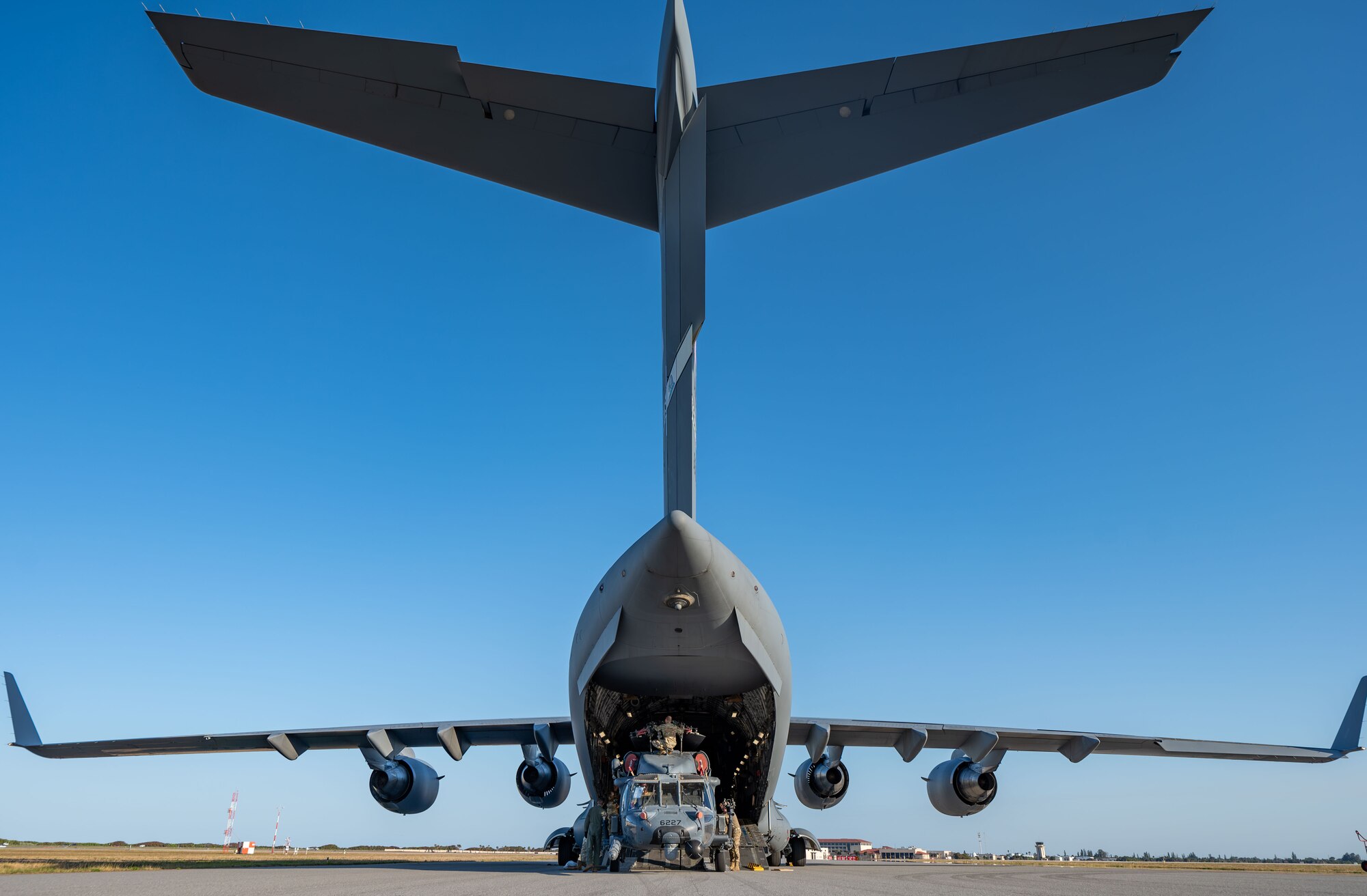 Airmen loaded two retiring HH-60G Pave Hawk helicopters into a C-17 Globemaster III aircraft