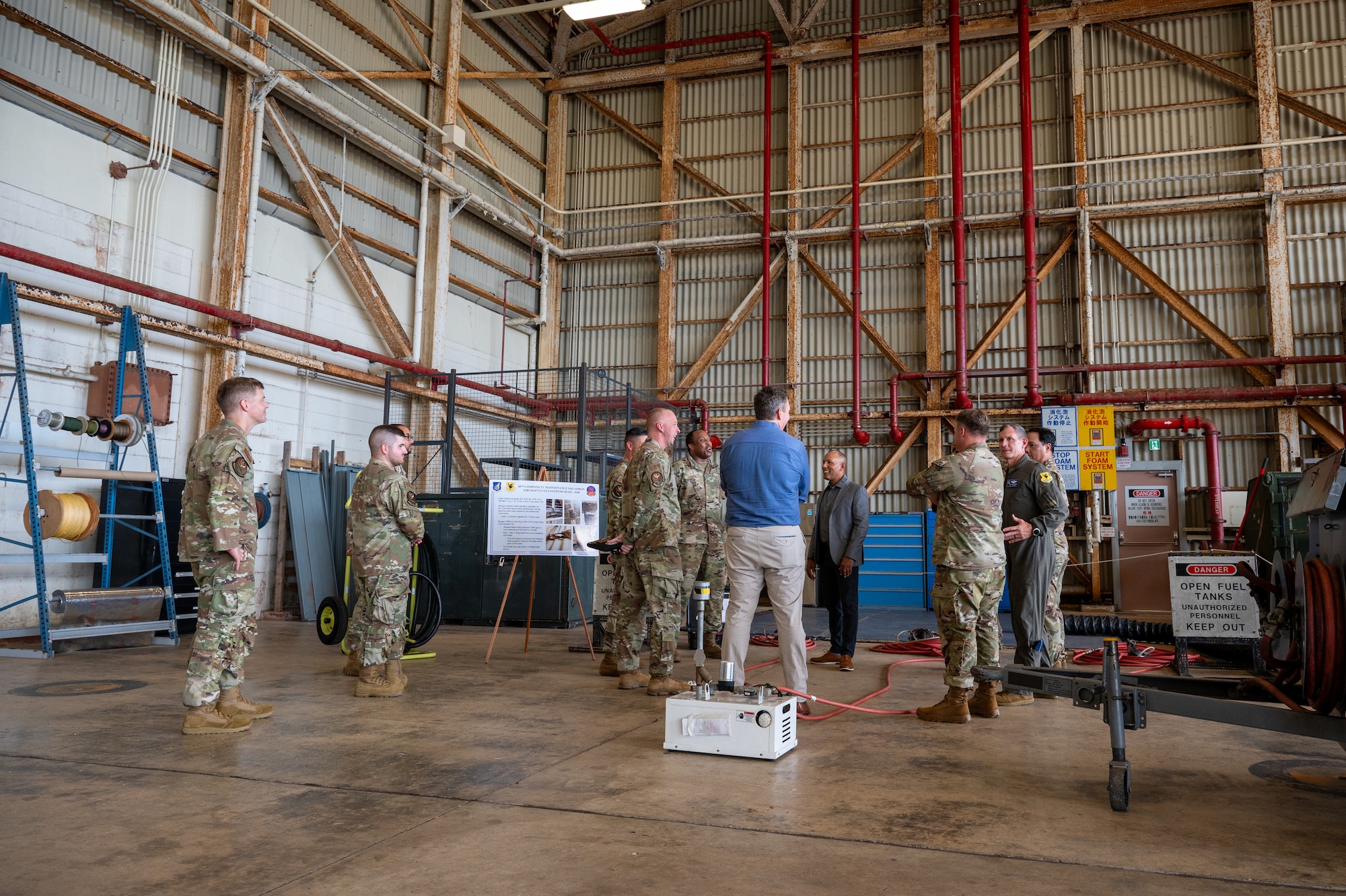 people stand around talking to each other during a base tour