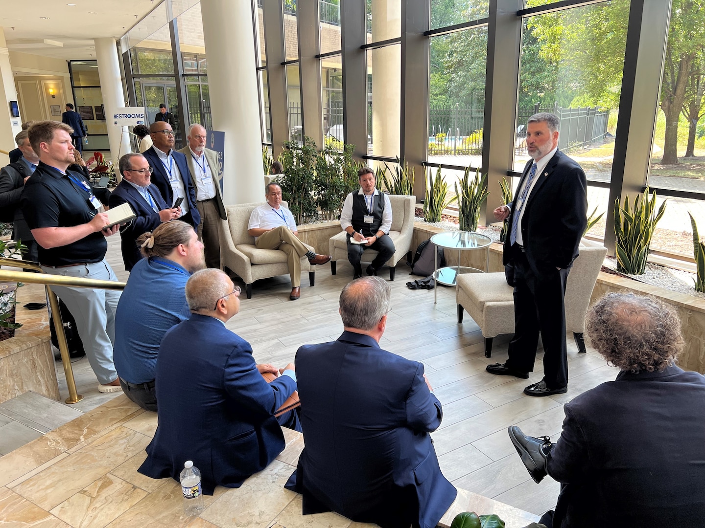 Man speaking in front of group of people.
