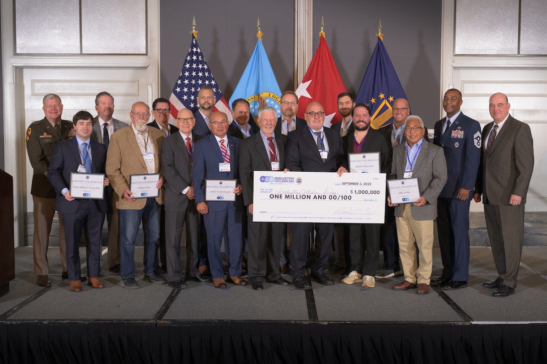 Group of award winners holding large check.