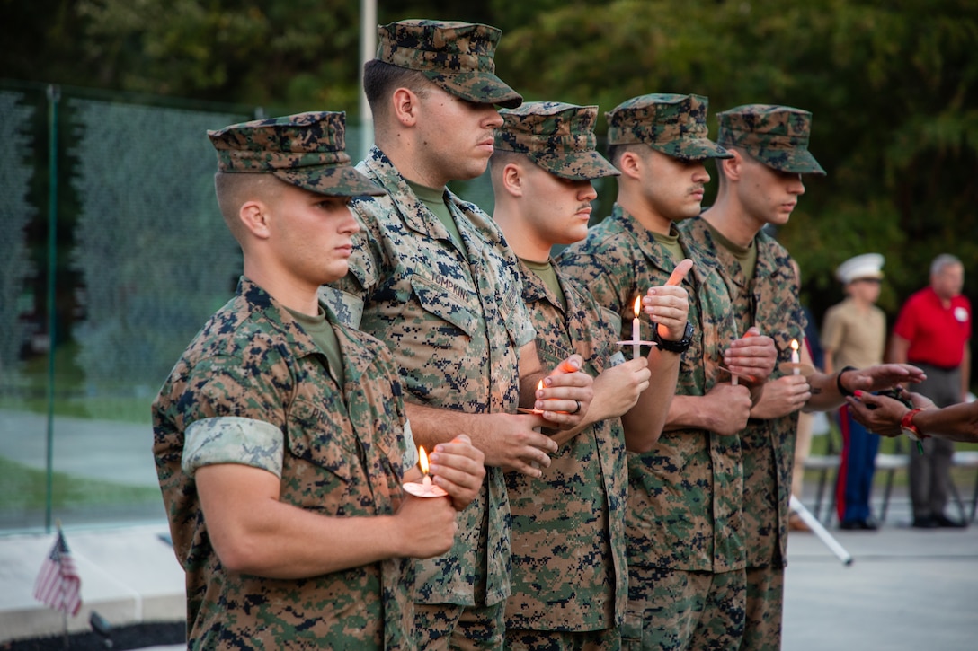 U.S. Marines hold candles in remembrance of the service members killed during the Kabul Airlift during a candlelight vigil held at the Lejeune Memorial Gardens, Jacksonville, North Carolina, August 26, 2025. The candlelit vigil was led by volunteers with Remember Everyone Deployed on the four-year anniversary of the bombing during the Kabul Airlift. (U.S. Marine Corps photo by Cpl. Victoria Hutt)