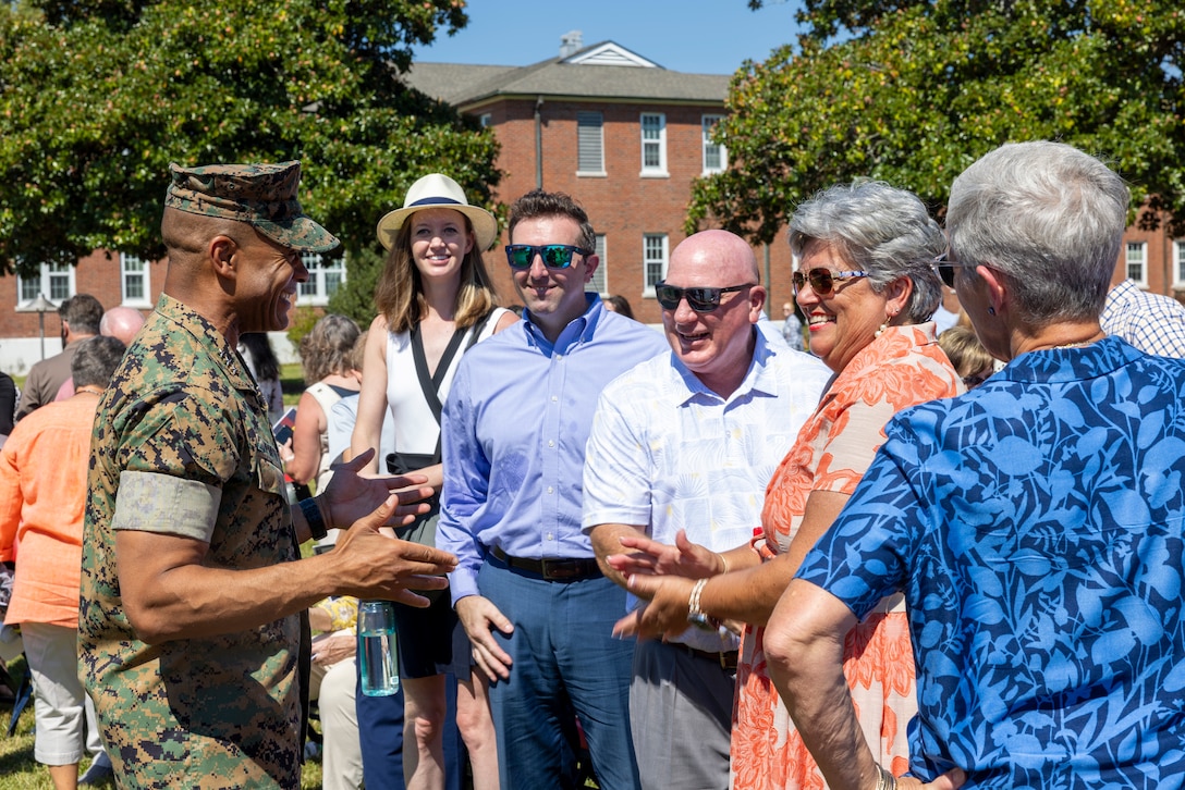 U.S. Marine Corps Lt. Gen. Calvert L. Worth Jr., commanding general, II Marine Expeditionary Force (MEF), thanks the family of Hope Fiorvanti, II Marine Expeditionary Force Chief of Protocol, during her retirement ceremony at Marine Corps Base Camp Lejeune, North Carolina, Sept. 5, 2025. For more than a decade, Fiorvanti served as a special staff officer for II MEF and was the subject matter expert on the planning, coordination and synchronization required to support all special events and Distinguished Visitors to the command. (U.S. Marine Corps Photo by Cpl. Adam Scalin)