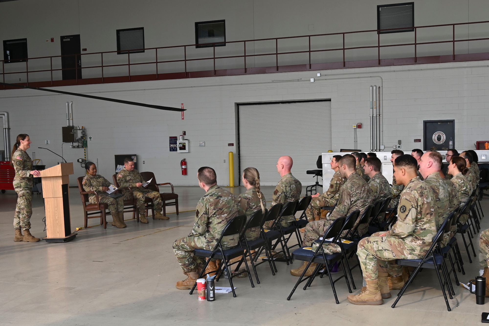 Maryland National Guard legal personnel listen to remarks given by Maryland Army National Guard Col. Marci Sam, state staff judge advocate for the Maryland National Guard at Weide Army Heliport at Aberdeen Proving Ground - South in Edgewood, Maryland, Sept. 6, 2025. The group was operating as part of an annual all-hands event for the Maryland National Guard legal offices. (U.S. Air National Guard photo by SSgt. Alexandra Huettner)