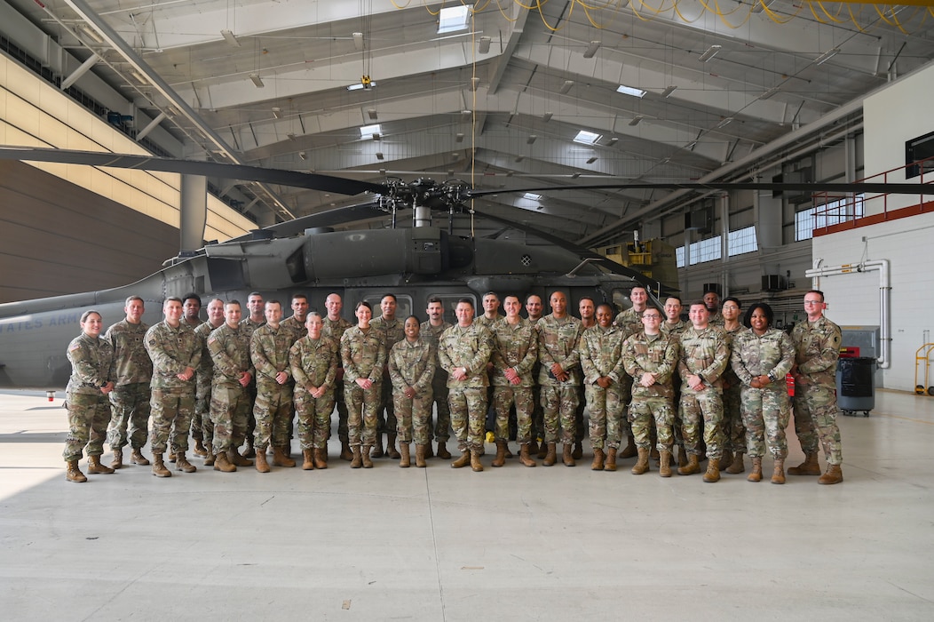 Maryland National Guard legal personnel pose for a group photo in front of a UH-60 Black Hawk at Weide Army Heliport at Aberdeen Proving Ground - South in Edgewood, Maryland, Sept. 6, 2025. The group was there as part of an annual all-hands event for the Maryland National Guard legal offices. (U.S. Air National Guard photo by SSgt. Alexandra Huettner)