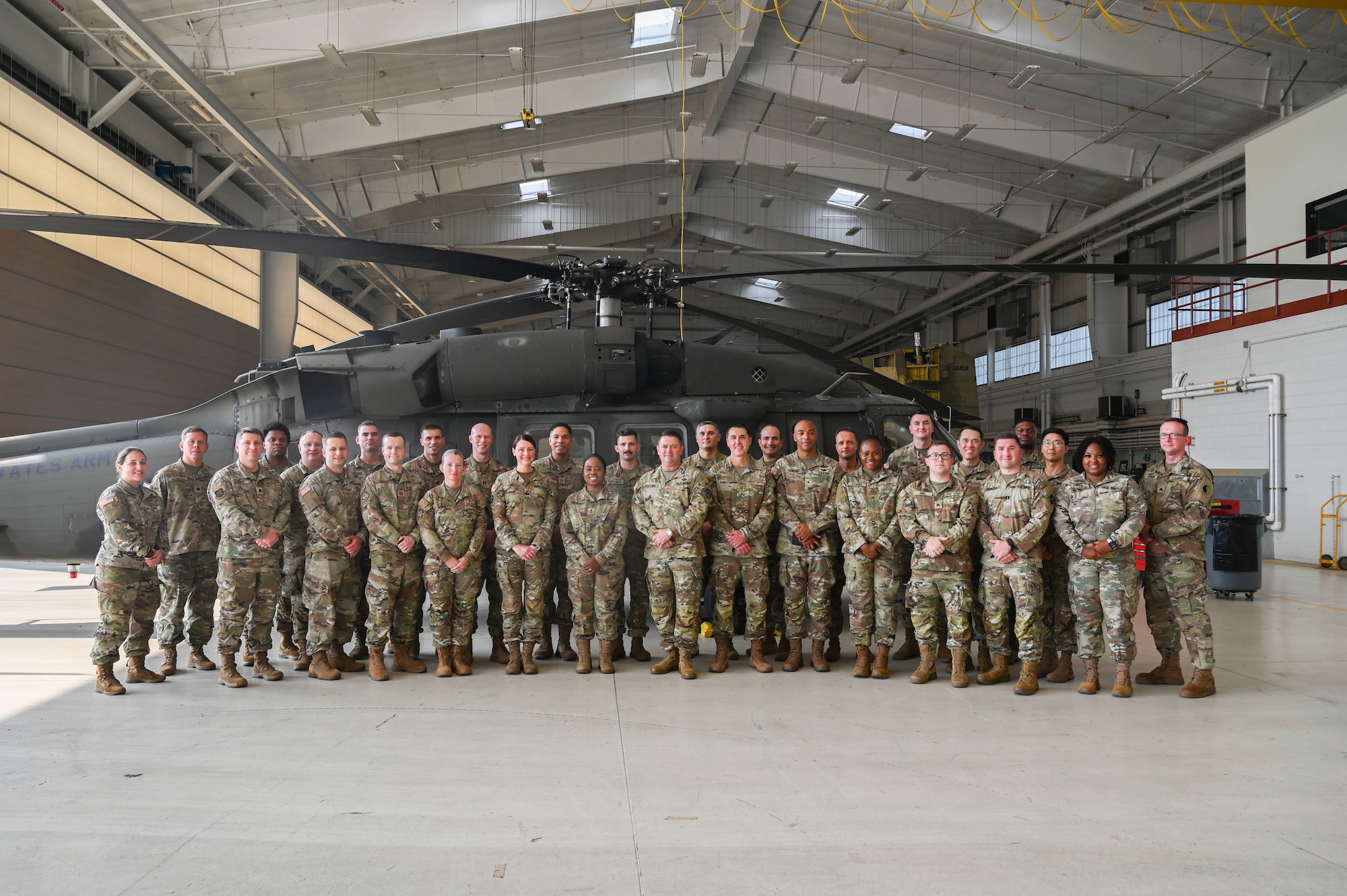 Maryland National Guard legal personnel pose for a group photo in front of a UH-60 Black Hawk at Weide Army Heliport at Aberdeen Proving Ground - South in Edgewood, Maryland, Sept. 6, 2025. The group was there as part of an annual all-hands event for the Maryland National Guard legal offices. (U.S. Air National Guard photo by SSgt. Alexandra Huettner)