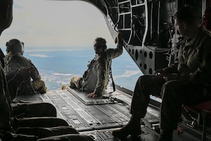 Maryland Army National Guard Staff Sgt. Hunter Cotsoradis, Brigade parallegal noncommissioned officer, takes part in a practice called ramp riding during a flight in a CH-47 Chinook helicopter at Weide Army Heliport at Aberdeen Proving Ground - South in Edgewood, Maryland, Sept. 6, 2025. The tours were part of an annual all-hands event for the Maryland National Guard legal offices. (U.S. Air National Guard photo by SSgt. Alexandra Huettner)