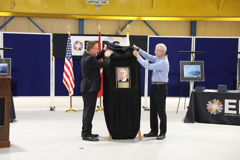 Dr. Ivan Beckman (left), director of the Cold Regions Research and Engineering Laboratory (CRREL), helps Randy Hill unveil a plaque marking Hill’s induction into the Gallery of Distinguished Employees.